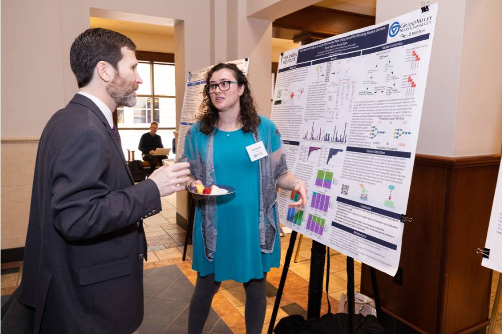 Anna (right) presenting to a guest at the 2023 Graduate Showcase.